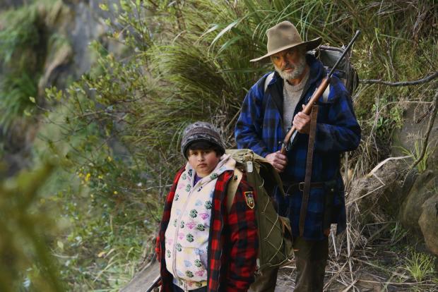 Man and young boy hiking on mountain