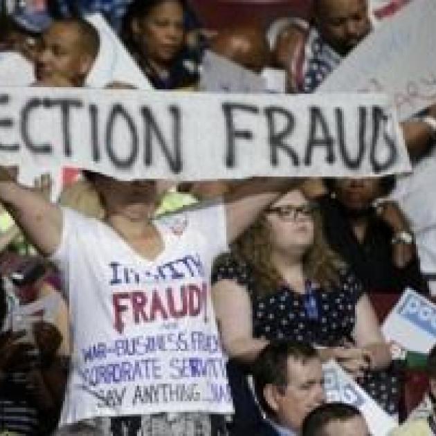 Bernie delegates holding up Election Fraud sign at DNC