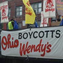 Big truck with signs to Boycott Wendy's at start of march down High Street