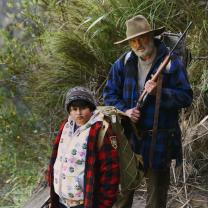 Man and young boy hiking on mountain