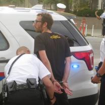 Activist being handcuffed by police