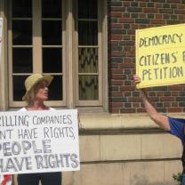 Two women holding protest signs