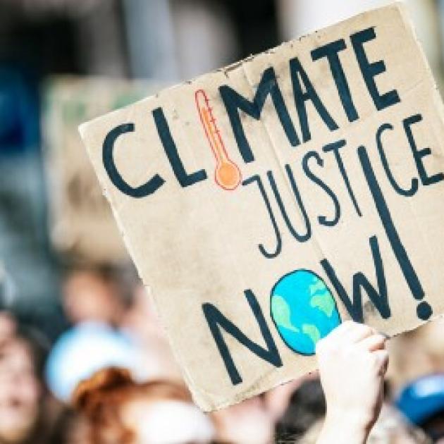 Sign saying climate justice now
