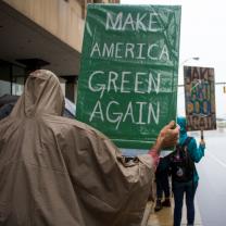 Person holding sign saying making American Green again