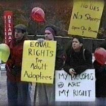 People outside holding protest signs saying Equal Rights for Adult Adoptees