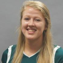 Young woman with long blonde hair in a green sports jersey 