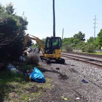 Bulldozer taking down a houseless encampment