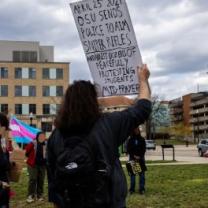 Young woman holding sign