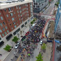 Downtown street with thousands of people marching