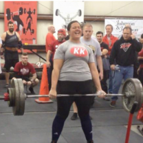 Young woman lifting barbells